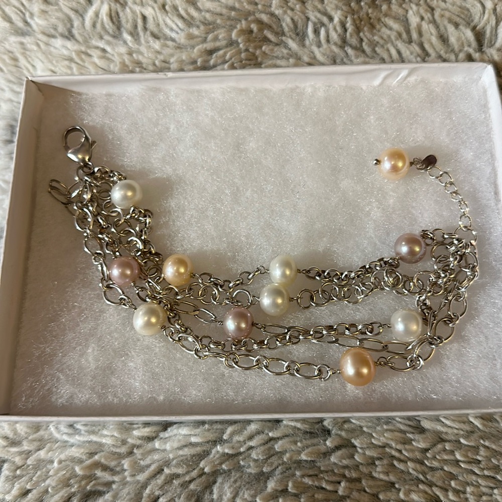 Sterling silver muti strand bracelet. Faux pearls. Excellent condition.